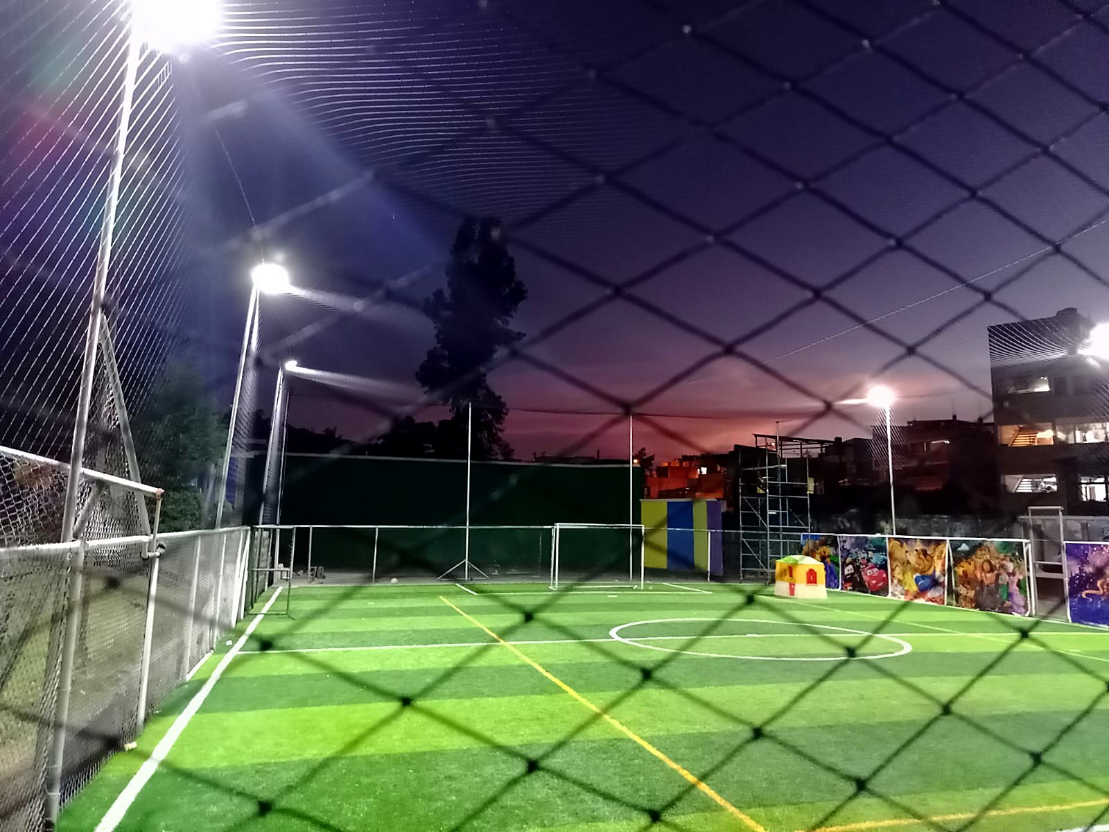 Cancha cerrada y techada, de noche